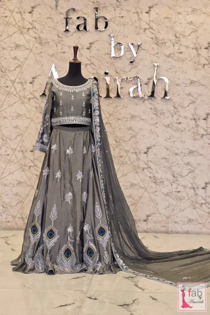Full length view of charcoal grey silk peacock motif lehenga set on mannequin