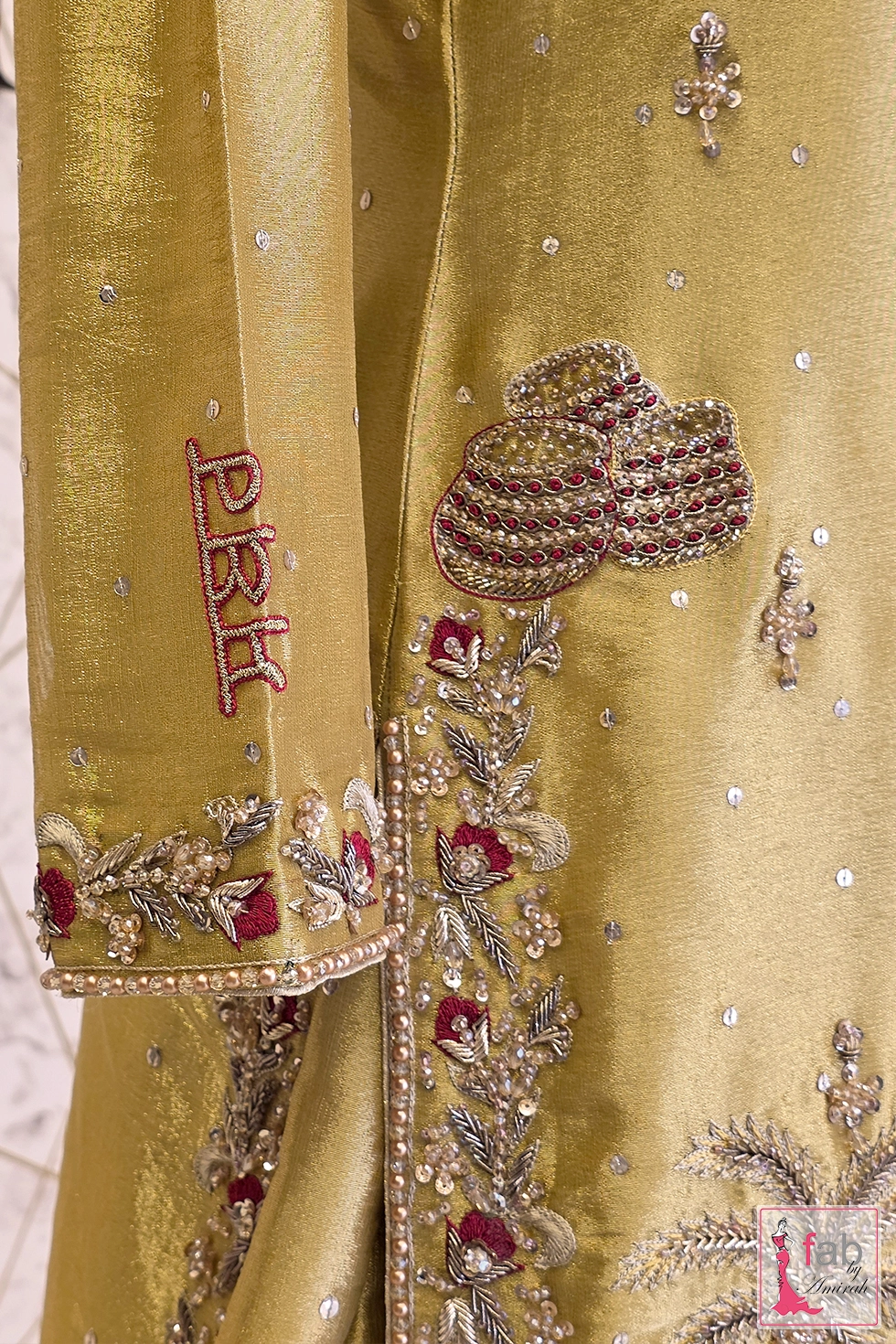 Detail shot of embroidered sleeve cuff and side slit border design