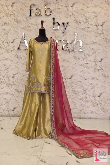 Olive green bridal sharara set featuring hand embroidery and magenta dupatta on display