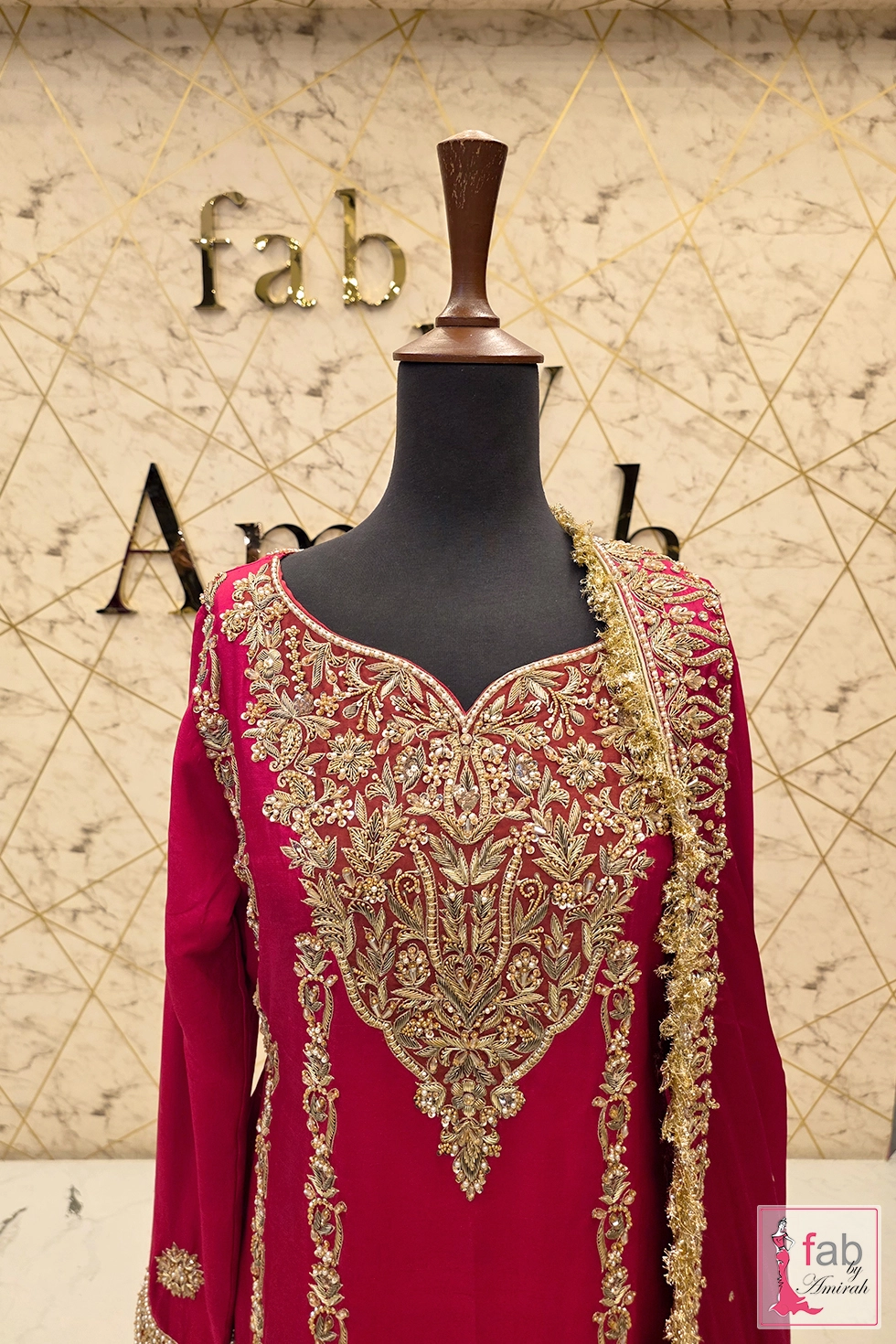 Close up detail of intricate hand zardozi stitching on sweetheart neckline.
