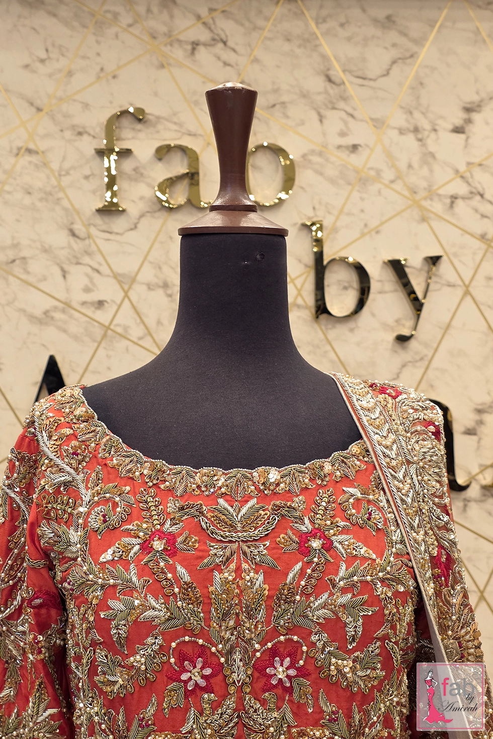 Detail shot of scoop neckline and front bodice hand embroidery