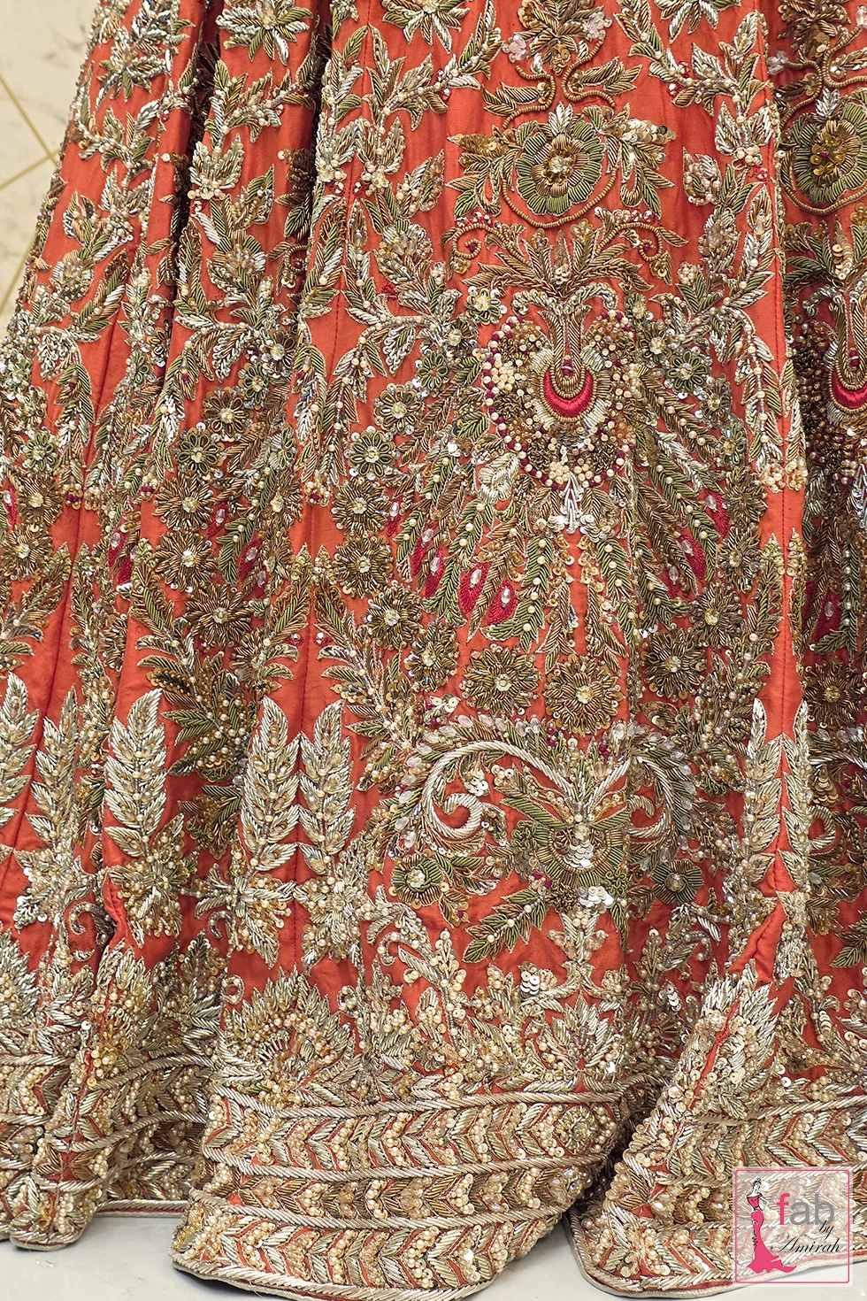 Extreme close up of hand zardozi embroidery, sequins, and pearl accents