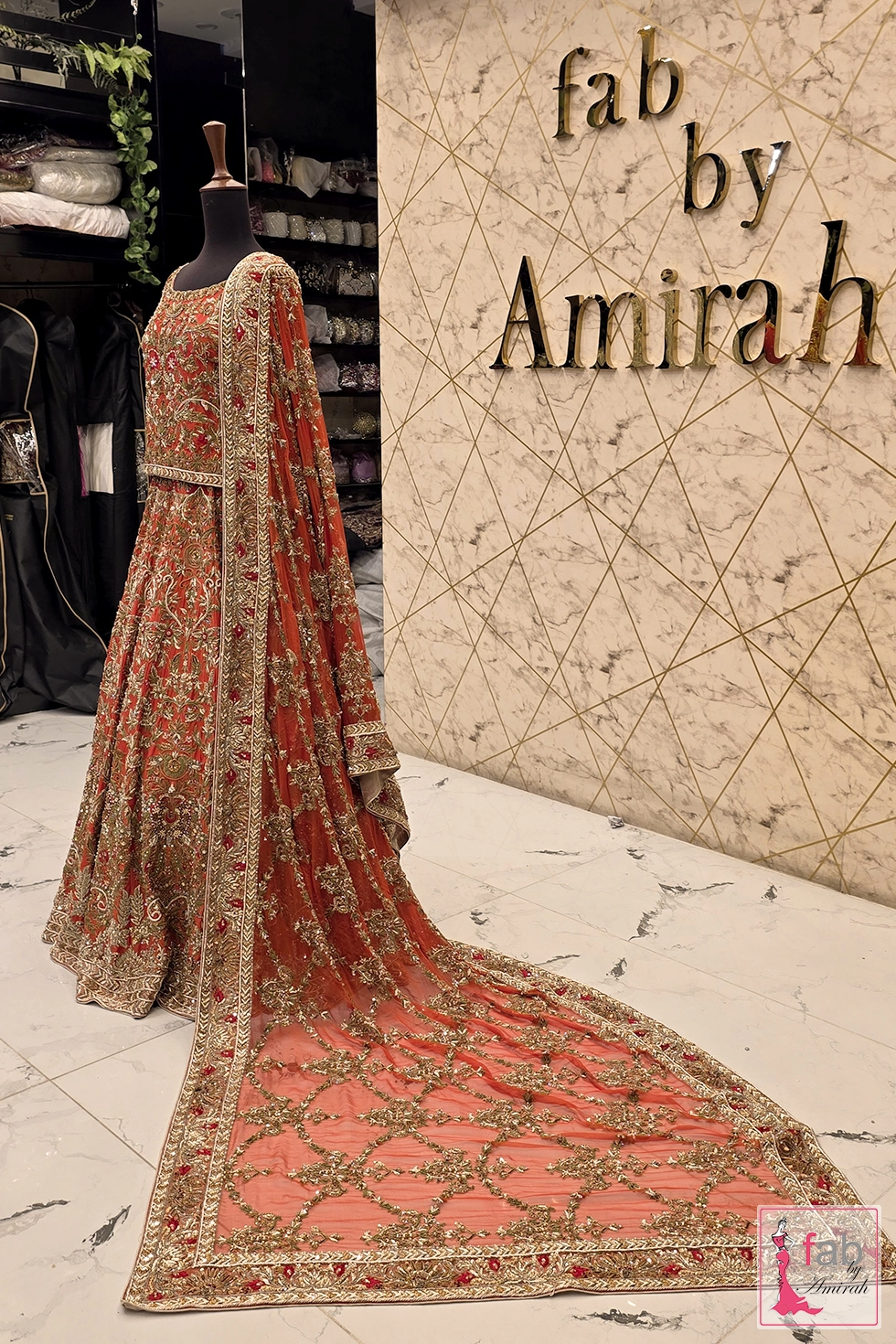 Full length angle displaying trailing net dupatta with gold embroidered borders
