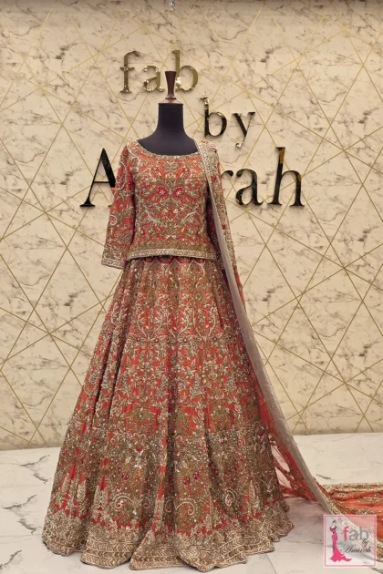 Rust bridal lehenga with hand embroidered gold zardozi on mannequin