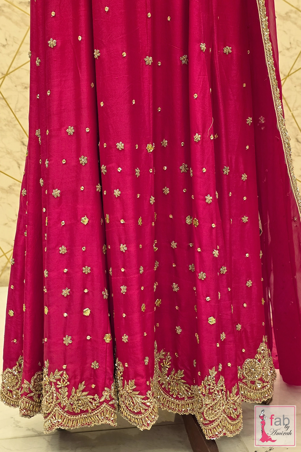 Bottom hemline flare showing gold border work and scattered bootis Bottom hemline flare showing gold border work and scattered bootis