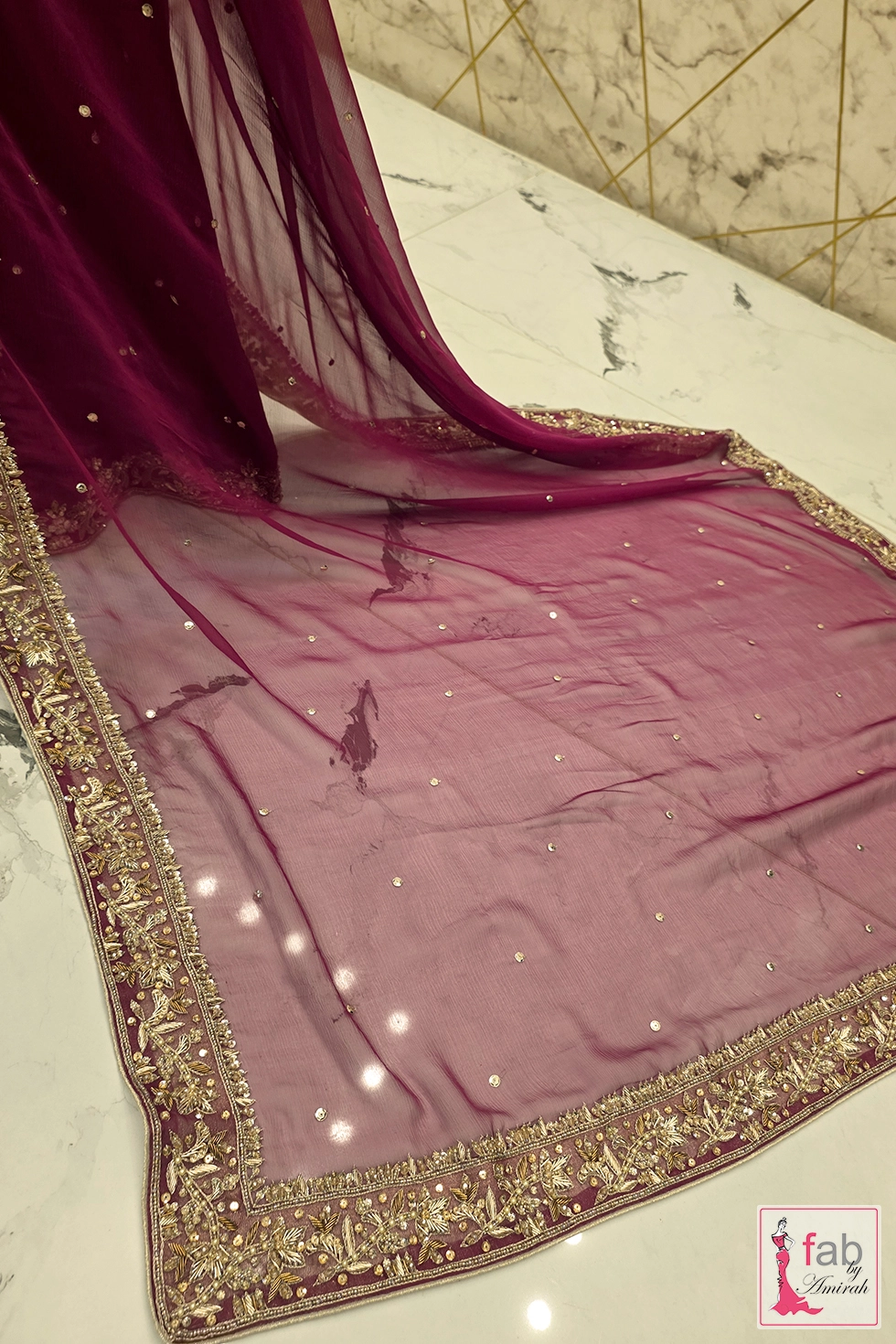 Sheer magenta organza dupatta with elaborate embroidered border spread flat