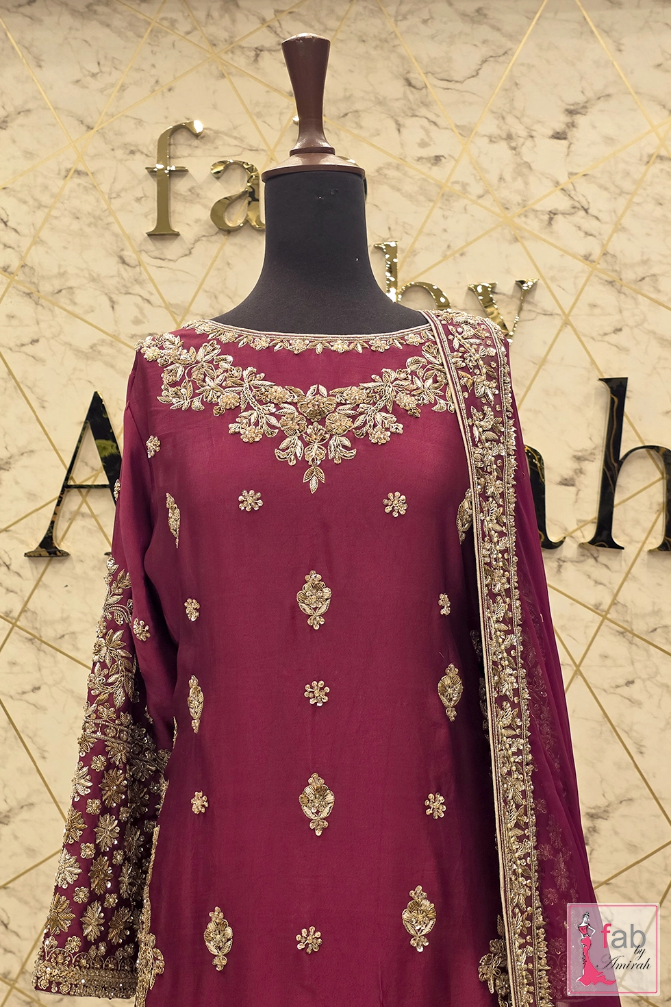 Upper torso view of embroidered shirt and dupatta draped on mannequin