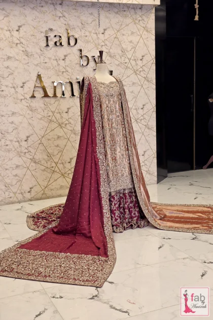 Wide angle studio shot of bridal ensemble featuring heavy maroon border dupatta drape