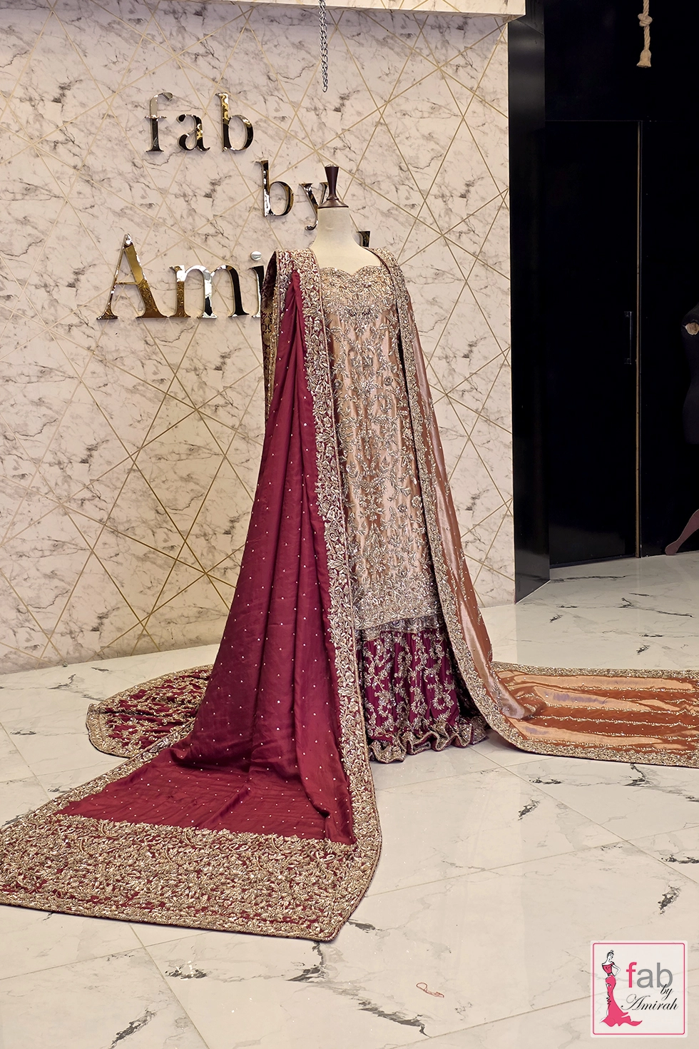 Wide angle studio shot of bridal ensemble featuring heavy maroon border dupatta drape
