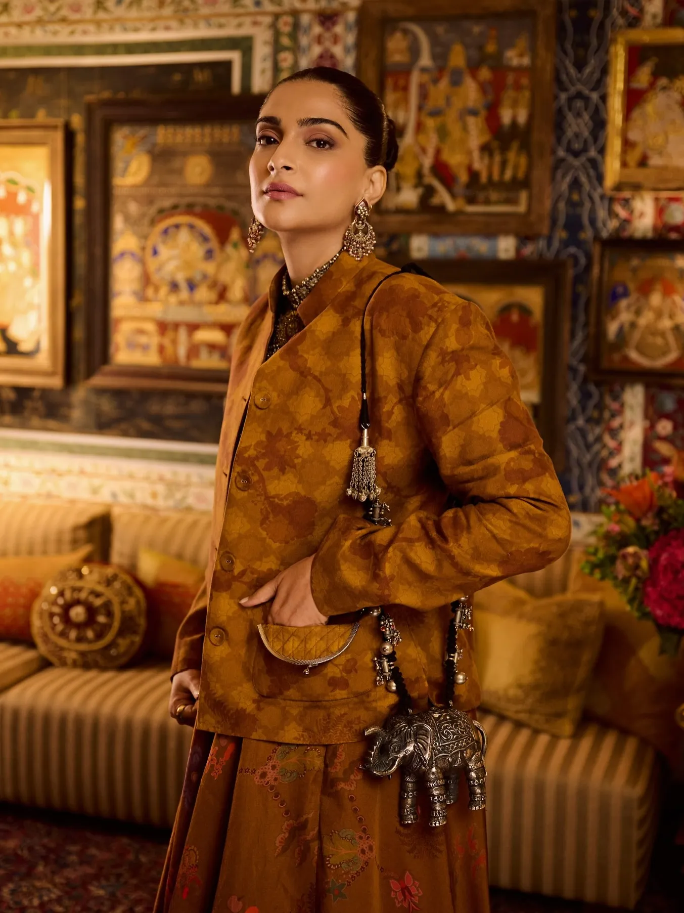 Sonam Kapoor holding embroidered cross-body bag